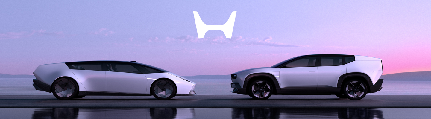 Two Honda 0 EV series vehicles are pictured parked in front of one another with their refelctions in a large pool, with a pink sunset in the background.