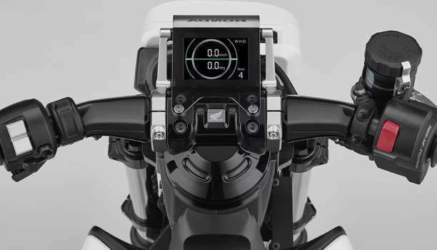 Handlebars of a Honda Assist-e motorcyle are show from above in a neutral space. 